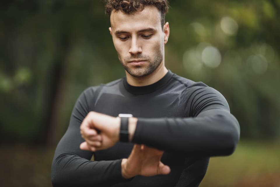 Runner checking his heart rate on a sports watch